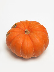 Single orange pumpkin on a white background.