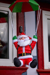 Santa Claus jumped with a parachute out of the window. Christmas miracles. New Year.