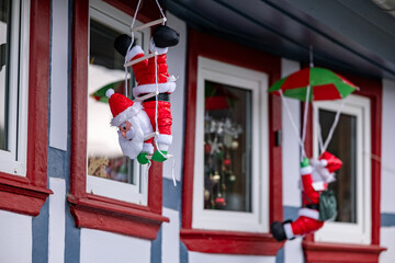 Christmas decor. Figure of decorative Santa Claus on the facade of the house.