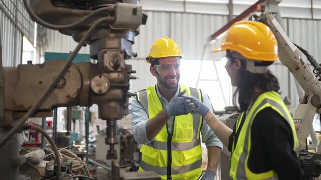 Blue collar workers at machine shop with coring machine. Factory and machinery.