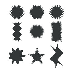 Collection of nine abstract dark gray jagged starburst and geometric shapes in a silhouette style