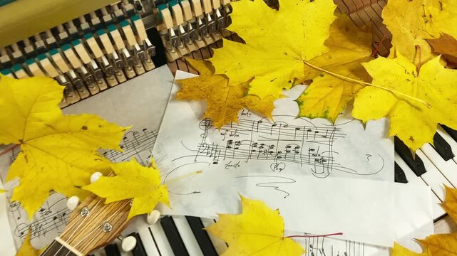 Acoustic Autumn Duet: A beautiful wooden ukulele rests on the keys of an old upright piano, surrounded by golden maple leaves and handwritten sheet music
