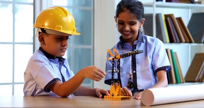 Indian School Kids Studying Crane Mechanism Using 3D Model in Classroom While Wearing School Uniform, Safety Hard Hats, Focused on Engineering Concepts During Academic Activity
