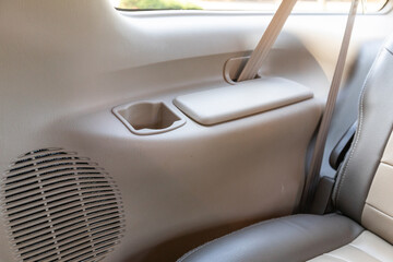 Interior photo of an older 2004 American 4x4 family suv truck highlighting clean and well-preserved beige color cabin details, speakers, door window power switches  