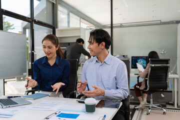 Business consultants discuss tax, merger strategy and restructuring in modern office.