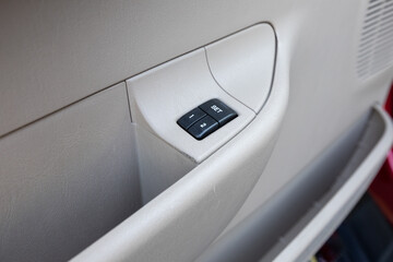 Interior photo of an older 2004 American 4x4 family suv truck highlighting clean and well-preserved beige color cabin details, speakers, door window power switches  