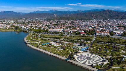 Fototapeta premium An aerial drone photo of the stunning Fethiye coastline park and promenade area with beautiful landscaping alongside the turquoise Mediterranean Sea