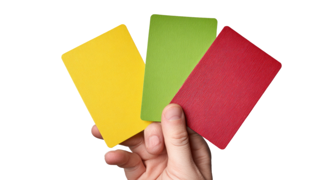 A hand displays a fan of three brightly colored cards; yellow, green, and red, against black