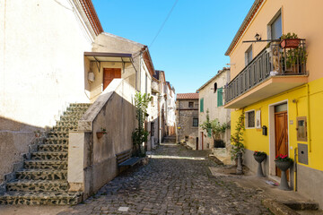 Fototapeta premium A narrow street among the old houses of Atena Lucana, a village in the province of Salerno, Italy.