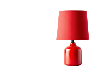 Vivid red table lamp with a cylindrical shade against a stark black background