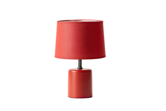A small, modern table lamp with a red shade and base against a stark black background