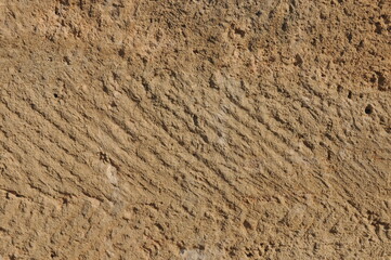 Unique texture of rock surface showing natural patterns in a desert environment under bright...
