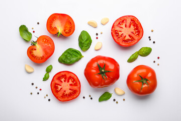 Fototapeta premium Ripe red tomatoes, peppercorns, garlic and basil on white background, flat lay