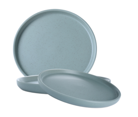 photograph of a modern ceramic dinnerware set, featuring speckled blue-grey plates and bowls arranged artistically and isolated against a dark, dramatic background.