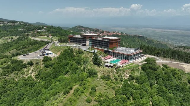 Sighnaghi, Georgia - July 15 2025: Aerial view of modern hilltop hotel Bodbe. Complex with Pool Terrace Overlooking Lush Green Valleys and Distant Horizon over Sighnaghi city