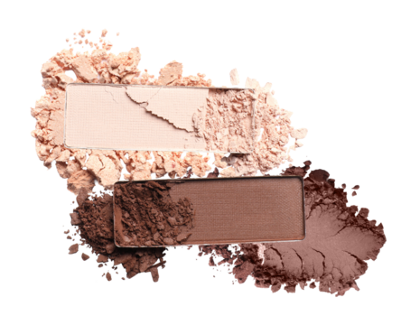 close-up photograph of two rectangular eyeshadow pans with crushed cosmetic powder scattered around them, featuring nude and deep brown shades isolated on black.