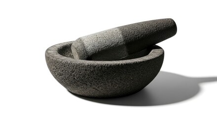 Textured stone mortar and pestle, a traditional kitchen tool for grinding spices, isolated on white.