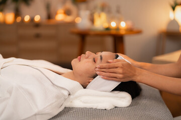Adult Asian Woman Receives Rejuvenating Facial Massage Spa Treatment for Ultimate Relaxation...