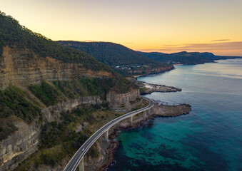 Aerial view of the Sea Cliff Bridge and coastal cliffs at sunrise in New South Wales, Australia