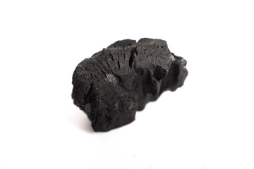 Pile of natural wood charcoal pieces on a white background, showing rough texture and irregular shapes. Suitable for barbecue, grilling, eco fuel, or energy industry product presentation and design us