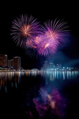 Obraz premium Spectacular purple fireworks over city skyline reflected in water at night