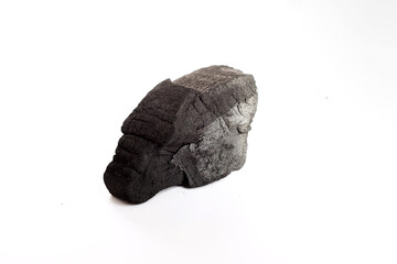 natural charcoal piece isolated on white background, showing rough porous texture and matte black surface, ideal for design projects about energy, fuel, art materials, or organic texture