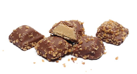 Caramel wafers, covered milk chocolate with caramel flakes isolated on white background, side view