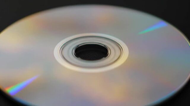 Close-up of a reflective compact disc showing rainbow colors