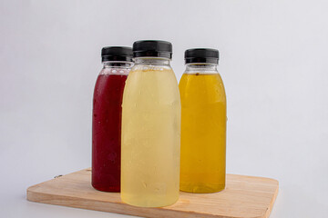 Fruit juice in a clear bottle on a white background