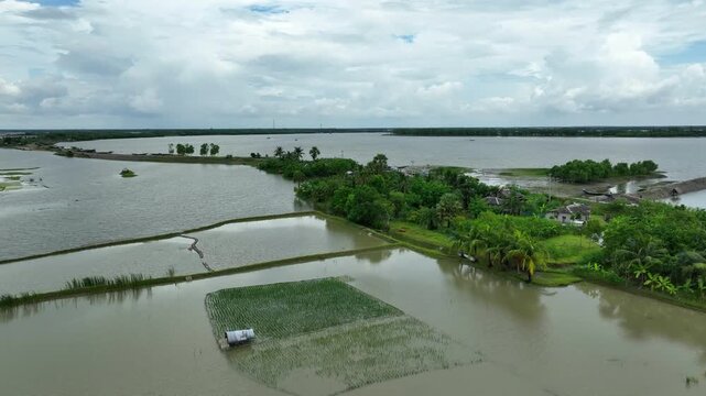 Aerial view of agricultural fields, homes, roads submerged in flood caused by collapse of river embankment due to strong tidal surge, Satkhira region, Bangladesh