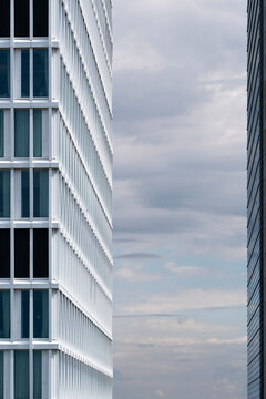 Contemporary architectural facade with minimal glass geometry and metallic reflections under soft urban light creating modern composition and structural rhythm in city architecture