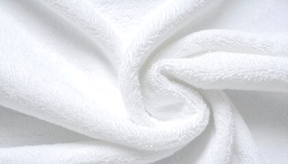 Close-up shot revealing soft, pristine white plush fabric twisted into elegant curves. The texture shows detailed fuzziness, highlighting softness