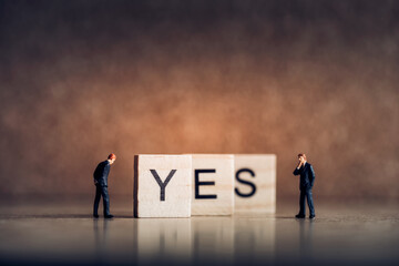 Wooden tiles forming word YES. Business concept