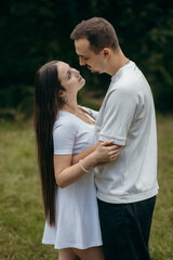 Fototapeta premium Young couple walking at nature at summer 
