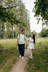 Fototapeta premium Young couple walking at nature at summer 