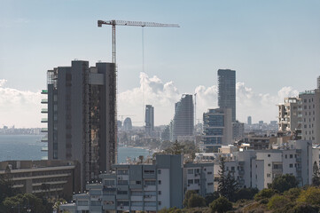 Construction crane building modern skyscraper in Limassol city. Cyprus