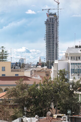 Modern skyscraper building towering over old town of Limassol, Cyprus