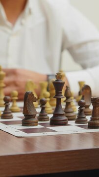 Chessboard with pieces, side view