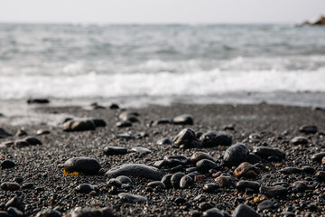 Black cobblestones on a volcanic beach.
