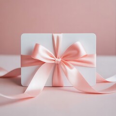 Elegant white gift card with a pink ribbon isolated on white background
