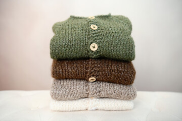 Pile of soft warm knit clothes in natural colors