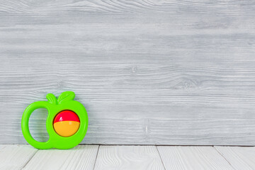 baby rattle on wooden background