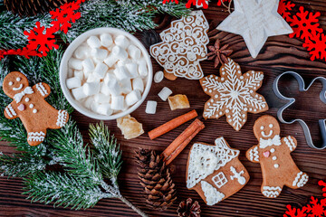 Christmas gingerbread, spruce branches on dark wooden background top view