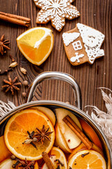 preparation of mulled wine in pot wooden background top view