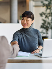 Group of young business people having a meeting shaking hands handshake introducing each other or...