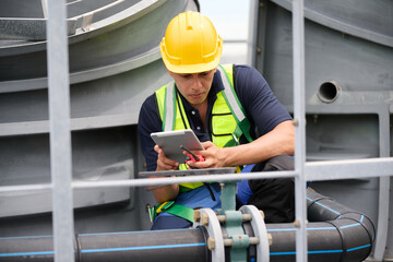 A professional worker focused on his tablet while inspecting a construction site