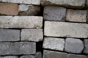 A close-up of a masonry of gray bricks stacked on top of each other