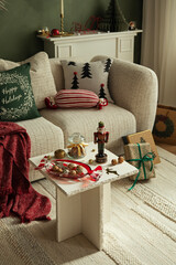 Festive arrangement with Christmas gifts, red blanket, and green “Happy Holidays” pillow. A warm and elegant seasonal living room scene.