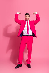 Charming young man in a bright pink suit radiates confidence and style in a vibrant and fashionable celebratory vibe