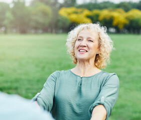 Happy active middle aged couple, portrait of a mid age woman with her husband dancing or swinging...